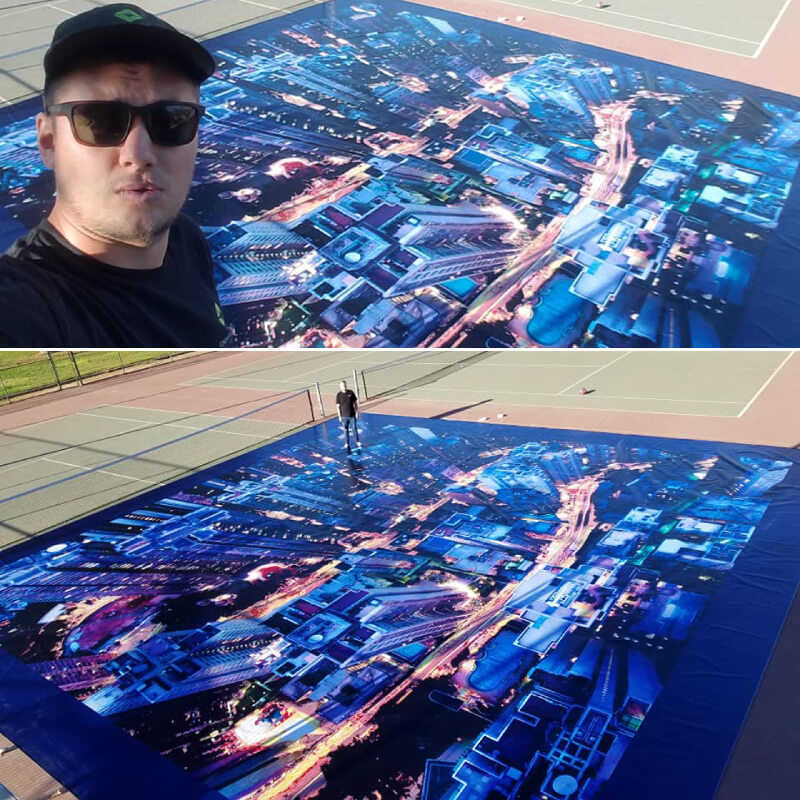 A huge printed 46 by 46 foot graphic depecting a bird's eye view of a city